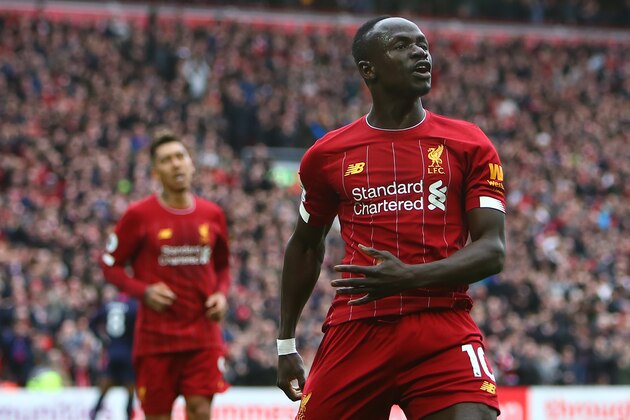 Liverpool's Senegalese striker Sadio Mane celebrates scoring his team's second goal during the English Premier League football match between Liverpool and Bournemouth at Anfield in Liverpool, north west England on March 7, 2020. (Photo by GEOFF CADDICK / AFP) / RESTRICTED TO EDITORIAL USE. No use with unauthorized audio, video, data, fixture lists, club/league logos or 'live' services. Online in-match use limited to 120 images. An additional 40 images may be used in extra time. No video emulation. Social media in-match use limited to 120 images. An additional 40 images may be used in extra time. No use in betting publications, games or single club/league/player publications. /  (Photo by GEOFF CADDICK/AFP via Getty Images)
