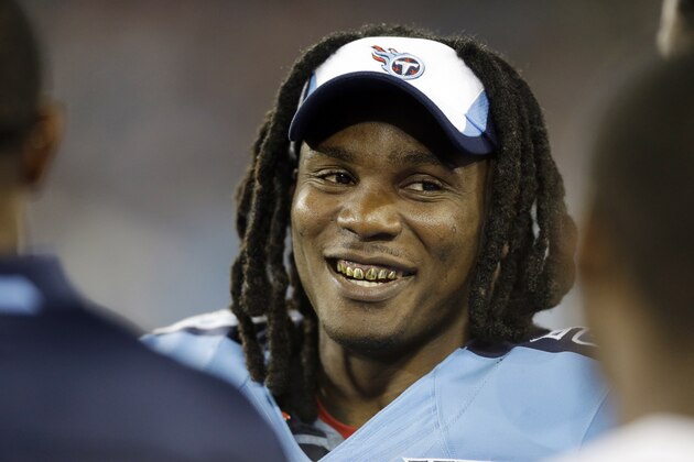 FILE - In this Aug. 8, 2013 file photo, Tennessee Titans running back Chris Johnson talks with teammates on the sideline in the third quarter of a preseason NFL football game against the Washington Redskins, in Nashville, Tenn. The Titans have told Chris Johnson they are releasing him after six seasons to avoid paying the $8 million the running back is due in pay in 2014, and the final three seasons left on the $53.5 million contract he signed in September 2011. The Titans announced Johnson has been told he will be released Friday, April 4, 2014. (AP Photo/Wade Payne, File)
