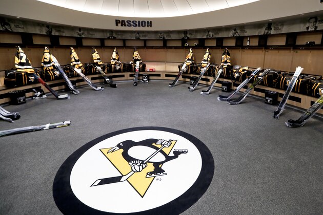 The team logo is in the center of the Pittsburgh Penguins locker room before players come in to talk to the media before leaving for the off season two days after being swept by the New York Islanders in the first round of the NHL hockey playoffs, Thursday, April 18, 2019, at their practice facility in Cranberry Township, Pa. (AP Photo/Keith Srakocic)
