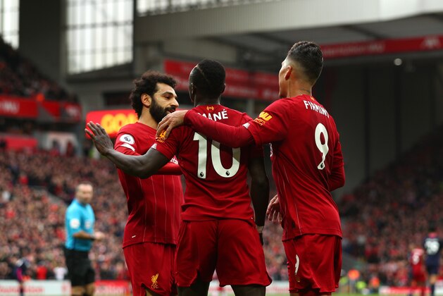 LIVERPOOL, ENGLAND - MARCH 07: Sadio Mane of Liverpool celebrates with Mohamed Salah and Roberto Firmino after scoring his team's second goal during the Premier League match between Liverpool FC and AFC Bournemouth  at Anfield on March 07, 2020 in Liverpool, United Kingdom. (Photo by Jan Kruger/Getty Images)