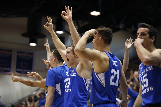 BYU players react on the bench after a score against Pepperdine during the second half of an NCAA college basketball game Saturday, Feb. 29, 2020, in Malibu, Calif. (AP Photo/Ringo H.W. Chiu)