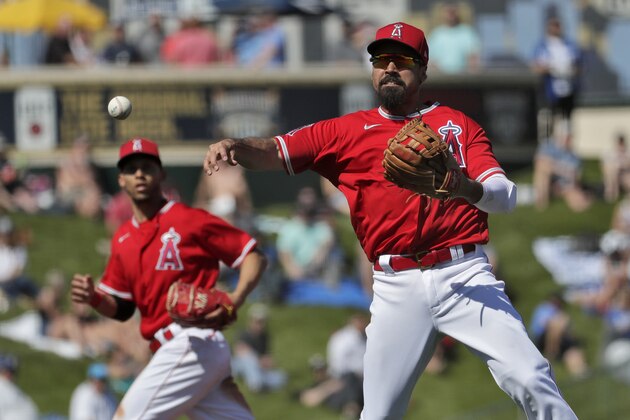 Los Angeles Angels' Anthony Rendon fields a ground out hit by Seattle Mariners' Shed Long Jr. during the third inning of a spring training baseball game Wednesday, March 4, 2020, in Tempe, Ariz. (AP Photo/Matt York)