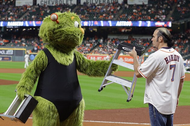 HOUSTON, TEXAS - SEPTEMBER 18: Houston Astros mascot Orbit challenges WWE wrestler Matt hardy to a