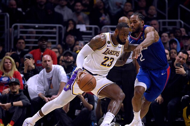 LOS ANGELES, CALIFORNIA - MARCH 08:  LeBron James #23 of the Los Angeles Lakers drives to the basket on Kawhi Leonard #2 of the LA Clippers during the first half at Staples Center on March 08, 2020 in Los Angeles, California.   NOTE TO USER: User expressly acknowledges and agrees that, by downloading and or using this photograph, User is consenting to the terms and conditions of the Getty Images License Agreement.  (Photo by Harry How/Getty Images)