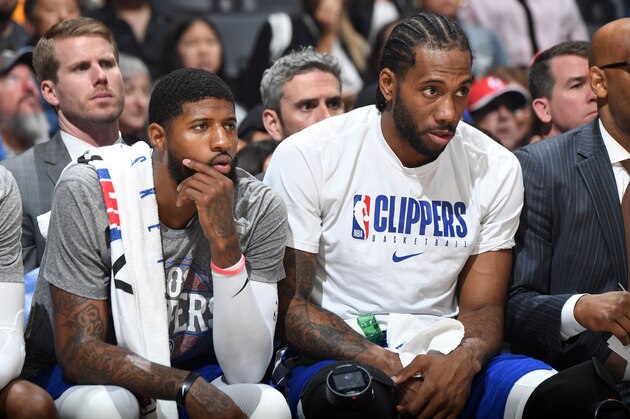 LOS ANGELES, CA - MARCH 8: Paul George #13 of the LA Clippers and Kawhi Leonard #2 of the LA Clippers look on during the game against the Los Angeles Lakers on March 8, 2020 at STAPLES Center in Los Angeles, California. NOTE TO USER: User expressly acknowledges and agrees that, by downloading and/or using this Photograph, user is consenting to the terms and conditions of the Getty Images License Agreement. Mandatory Copyright Notice: Copyright 2020 NBAE (Photo by Andrew D. Bernstein/NBAE via Getty Images)