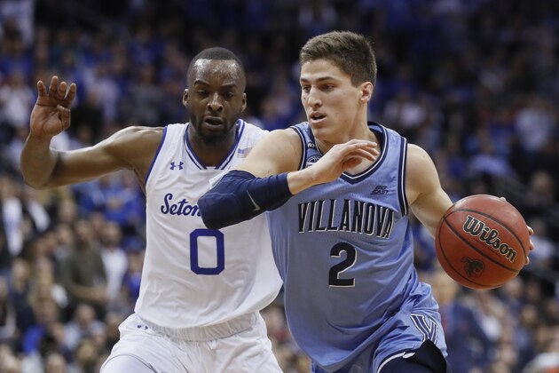 Villanova's Collin Gillespie (2) drives past Seton Hall's Quincy McKnight (0) during the first half of an NCAA college basketball game, Wednesday, March 4, 2020, in Newark, N.J. (AP Photo/John Minchillo)