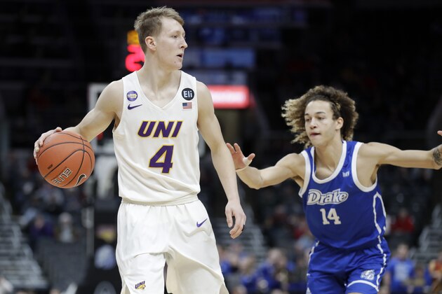 Northern Iowa's AJ Green (4) dribbles as Drake's Noah Thomas (14) defends during the second half of an NCAA college basketball game in the quarterfinal round of the Missouri Valley Conference men's tournament Friday, March 6, 2020, in St. Louis. (AP Photo/Jeff Roberson)