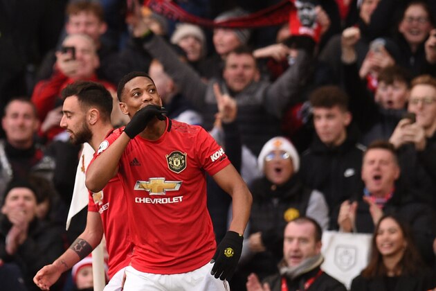 Manchester United's French striker Anthony Martial (1st-R) celebrates scoring his team's first goal during the English Premier League football match between Manchester United and Manchester City at Old Trafford in Manchester, north west England, on March 8, 2020. (Photo by Oli SCARFF / AFP) / RESTRICTED TO EDITORIAL USE. No use with unauthorized audio, video, data, fixture lists, club/league logos or 'live' services. Online in-match use limited to 120 images. An additional 40 images may be used in extra time. No video emulation. Social media in-match use limited to 120 images. An additional 40 images may be used in extra time. No use in betting publications, games or single club/league/player publications. /  (Photo by OLI SCARFF/AFP via Getty Images)