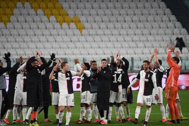 Juventus' players celebrate their victory over Inter Milan at the end of the Italian Serie A football match Juventus vs Inter Milan, at the Juventus stadium in Turin on March 8, 2020. - The match is played behind closed doors due to the novel coronavirus outbreak. (Photo by Vincenzo PINTO / AFP) (Photo by VINCENZO PINTO/AFP via Getty Images)