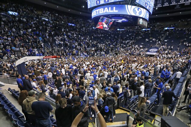 FILE - In this Feb. 22, 2020, file photo, BYU students and fans celebrate on the court following their victory over Gonzaga following an NCAA college basketball game, in Provo, Utah. Utah public health officials are contacting and testing BYU basketball fans who sat near a coronavirus patient at a game prior to the infection being diagnosed, the university said Monday, March 9, 2020. He had mild symptoms and there's little risk the virus was transmitted more widely the Feb. 22 game against Gonzaga, the school said in a statement. People who went to the game don't need to do anything unless the are contacted by the Utah County Health Department. (AP Photo/Rick Bowmer, File) FILE - In this Feb. 22, 2020, file photo, BYU students and fans celebrate on the court following their victory over Gonzaga following an NCAA college basketball game, in Provo, Utah. Utah public health officials are contacting and testing BYU basketball fans who sat near a coronavirus patient at a game prior to the infection being diagnosed, the university said Monday, March 9, 2020. He had mild symptoms and there's little risk the virus was transmitted more widely the Feb. 22 game against Gonzaga, the school said in a statement. People who went to the game don't need to do anything unless the are contacted by the Utah County Health Department. (AP Photo/Rick Bowmer, File)