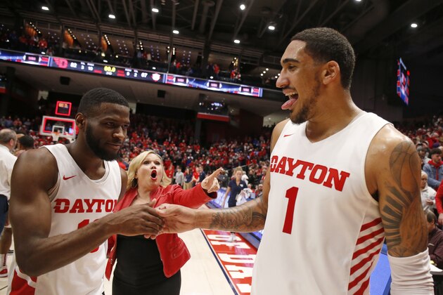 Dayton forward Obi Toppin (1) and guard Jalen Crutcher, left, celebrate the team's 82-67 win over Davidson in an NCAA college basketball game, Friday, Feb. 28, 2020, in Dayton, Ohio. Dayton won 82-67. (AP Photo/Gary Landers)