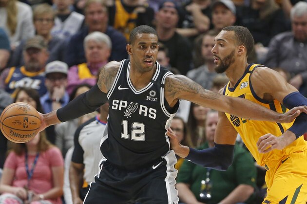 Utah Jazz center Rudy Gobert, right, guards San Antonio Spurs forward LaMarcus Aldridge (12) during the second half during an NBA basketball game Friday, Feb. 21, 2020, in Salt Lake City. (AP Photo/Rick Bowmer)