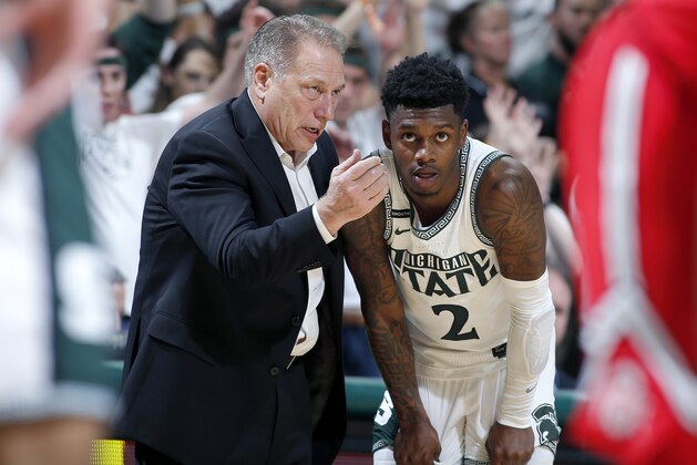 Michigan State coach Tom Izzo, left, talks with Rocket Watts during the second half of an NCAA college basketball game against Ohio State, Sunday, March 8, 2020, in East Lansing, Mich. (AP Photo/Al Goldis)