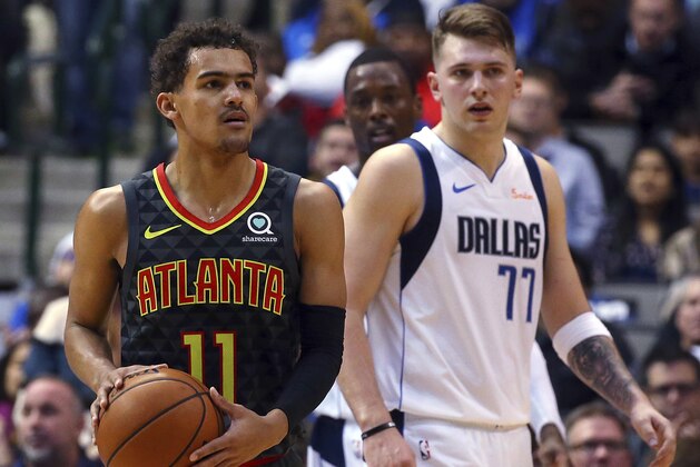 Atlanta Hawks guard Trae Young (11) and Dallas Mavericks forward Luka Doncic (77) stand on the court during the second half of an NBA basketball game Wednesday, Dec. 12, 2018, in Dallas. (AP Photo/Richard W. Rodriguez)