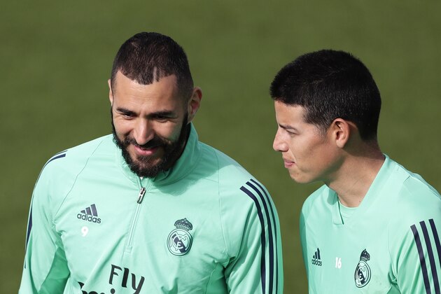 Real Madrid's Karim Benzema, left, and Real Madrid's James Rodriguez take part in a training session at the team's Valdebebas training ground in Madrid, Spain, Tuesday, Feb. 25, 2020. Real Madrid will play against Manchester City in a Champions League soccer match on Wednesday. (AP Photo/Manu Fernandez)