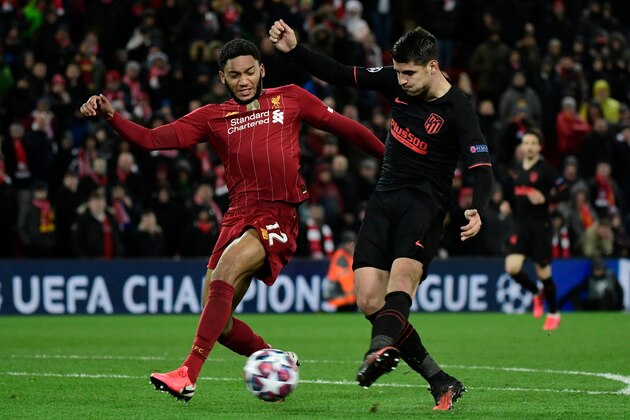Atletico Madrid's Spanish striker Alvaro Morata (R) celebrates scoring his team's third goal during the UEFA Champions league Round of 16 second leg football match between Liverpool and Atletico Madrid at Anfield in Liverpool, north west England on March 11, 2020. (Photo by JAVIER SORIANO / AFP) (Photo by JAVIER SORIANO/AFP via Getty Images)