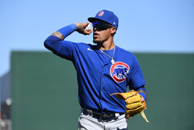 GOODYEAR, ARIZONA - MARCH 07: Javier Baez #9 of the Chicago Cubs throws a ball to fans during a spring training game against the Cleveland Indians at Goodyear Ballpark on March 07, 2020 in Goodyear, Arizona. (Photo by Norm Hall/Getty Images)