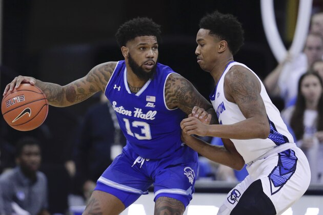 Seton Hall's Myles Powell (13) is guarded by Creighton's Ty-Shon Alexander, right, during the second half of an NCAA college basketball game in Omaha, Neb., Saturday, March 7, 2020. Creighton won 77-60. (AP Photo/Nati Harnik)