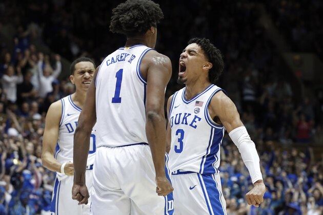 Duke guard Tre Jones (3) celebrates with center Vernon Carey Jr. (1) and forward Justin Robinson, left, during the second half of an NCAA college basketball game against North Carolina in Durham, N.C., Saturday, March 7, 2020. (AP Photo/Gerry Broome)