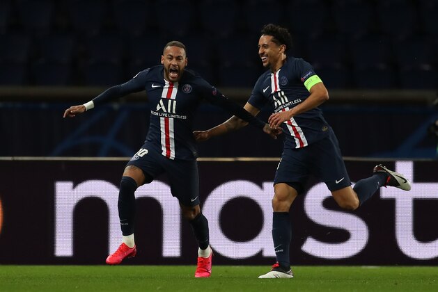 PARIS, FRANCE - MARCH 11: (FREE FOR EDITORIAL USE) In this handout image provided by UEFA, Neymar of Paris Saint-Germain celebrates with Marquinhos after scoring his team's first goal during the UEFA Champions League round of 16 second leg match between Paris Saint-Germain and Borussia Dortmund at Parc des Princes on March 11, 2020 in Paris, France. The match is played behind closed doors as a precaution against the spread of COVID-19 (Coronavirus).  (Photo by UEFA - Handout/UEFA via Getty Images)