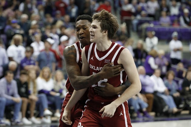 Oklahoma forward Kristian Doolittle, left, and guard Austin Reaves (12) celebrate a score By Reaves late in the second half of an NCAA college basketball game against TCU in Fort Worth, Texas, Saturday, March 7, 2020. (AP Photo/Tony Gutierrez)