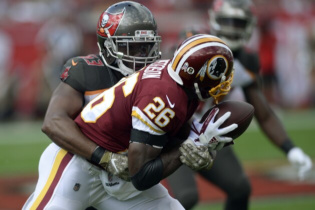 Washington Redskins running back Adrian Peterson (26) is stopped by Tampa Bay Buccaneers outside linebacker Adarius Taylor (53) after a catch during the first half of an NFL football game Sunday, Nov. 11, 2018, in Tampa, Fla. (AP Photo/Jason Behnken)