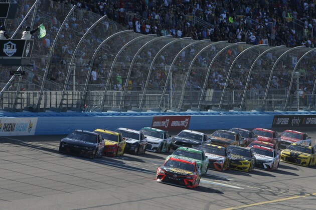 Martin Truex Jr. (19) leads the field through Turn 4 on a restart during the NASCAR Cup Series auto race at Phoenix Raceway, Sunday, March 8, 2020, in Avondale, Ariz. (AP Photo/Ralph Freso)