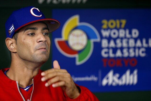 Cuba's outfielder Yoelkis Cespedes looks at Team Japan's work out before a first round game between Cuba and Japan at the World Baseball Classic at Tokyo Dome in Tokyo, Tuesday, March 7, 2017.(AP Photo/Shizuo Kambayashi)