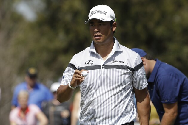 Hideki Matsuyama of Japan, hold his ball after making a birdie putt on the seventh hole, during the first round of The Players Championship golf tournament Thursday, March 12, 2020, in Ponte Vedra Beach, Fla. (AP Photo/Chris O'Meara)