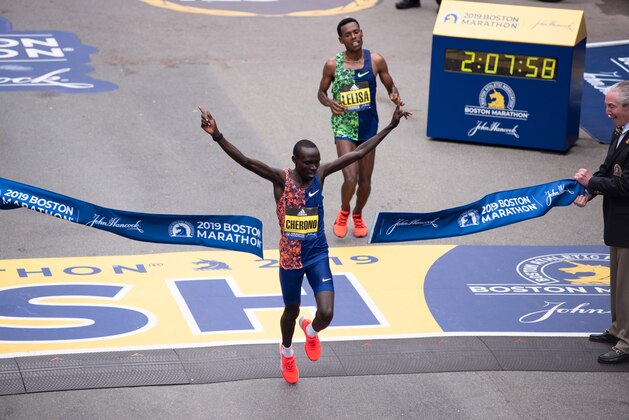 Kenyan Lawrence Cherono edges Ethopian Lelisa Desisa for first place for the Men's Elite race, at the 123rd Boston Marathon on April 15, 2019 in Boston, Massachusetts. - Kenya's Lawrence Cherono sprinted to victory in the Boston Marathon on Monday, overhauling Ethiopia's Lelisa Desisa in the final few metres of the gruelling race to claim a thrilling win. In damp, chilly conditions, Cherono, Desisa and Kenya's Kenneth Kipkemoi broke away from the field over the final few miles as the world's oldest major marathon reached a dramatic conclusion. Desisa, the 2013 World Champion and two-time Boston Marathon champion, looked to be on course for victory as he kicked for home in the final 200m.But with the crowds at Boston's famous Boylston Street finish line roaring them on, it was Cherono who timed his finish to perfection, overhauling the grimacing Desisa just a few metres from the tape to claim a magnificent win in 2hr 7min 57 sec. (Photo by RYAN MCBRIDE / AFP)        (Photo credit should read RYAN MCBRIDE/AFP v