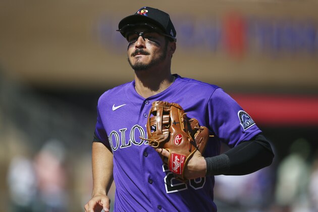Colorado Rockies third baseman Nolan Arenado runs back to the dugout after the final out during the second inning of a spring training baseball game against the Chicago Cubs Tuesday, March 3, 2020, in Scottsdale, Ariz. The Rockies defeated the Cubs 11-10. (AP Photo/Ross D. Franklin)
