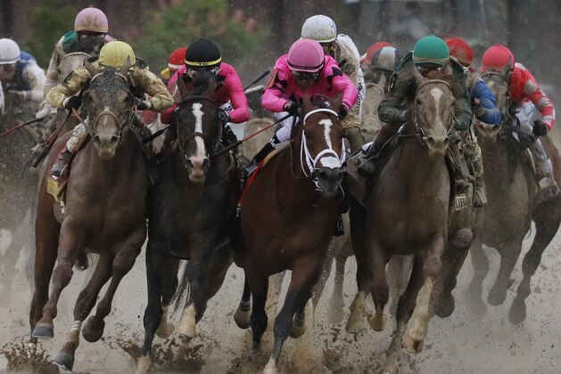Flavien Prat on Country House, left, races against Luis Saez on Maximum Security, third from left, during the 145th running of the Kentucky Derby horse race at Churchill Downs Saturday, May 4, 2019, in Louisville, Ky. Maximum Security was disqualified and Country House won the race. (AP Photo/John Minchillo)