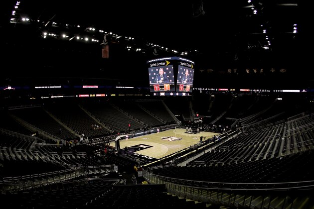 Big 12 commissioner Bob Bowlsby is seen on the big screen in an empty Sprint Center as he talks to the media after canceling the remaining NCAA college basketball games in the Big 12 Conference tournament due to concerns about the coronavirus Thursday, March 12, 2020, in Kansas City, Mo. (AP Photo/Charlie Riedel)