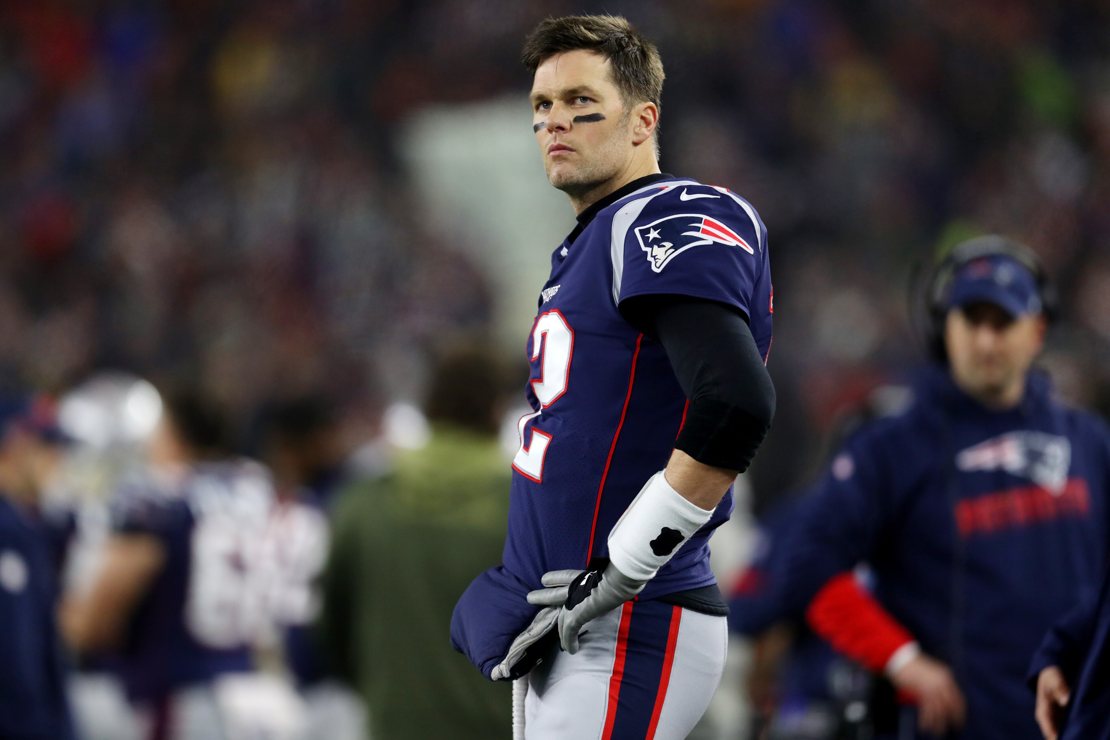 FOXBOROUGH, MASSACHUSETTS - JANUARY 04: Tom Brady #12 of the New England Patriots looks on from the sideline during the the AFC Wild Card Playoff game against the Tennessee Titans at Gillette Stadium on January 04, 2020 in Foxborough, Massachusetts. (Photo by Maddie Meyer/Getty Images)