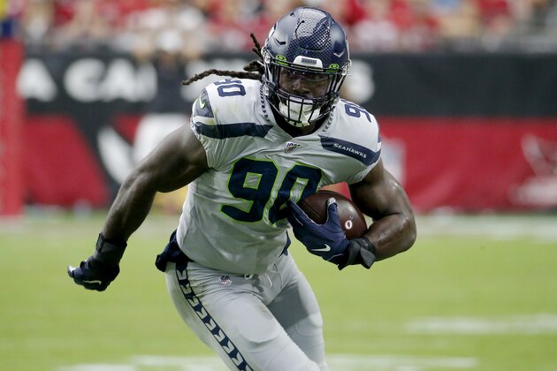 Seattle Seahawks outside linebacker Jadeveon Clowney (90) runs in an interception for a touchdown during the first half of an NFL football game against the Arizona Cardinals, Sunday, Sept. 29, 2019, in Glendale, Ariz. (AP Photo/Rick Scuteri)