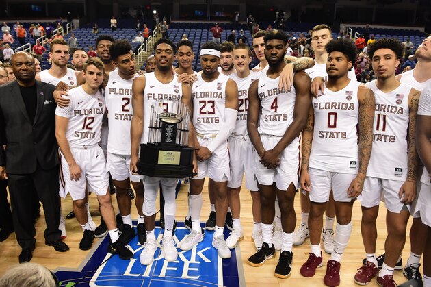 GREENSBORO, NORTH CAROLINA - MARCH 12: The Florida State Seminoles, lead by Head coach Leonard Hamilton (L), are presented with the regular season champion's trophy following the cancelation of the remainder of the 2020 Men's ACC Basketball Tournament at Greensboro Coliseum on March 12, 2020 in Greensboro, North Carolina. The cancelation is due to concerns over the possible spread of the Coronavirus (COVID-19). (Photo by Jared C. Tilton/Getty Images)