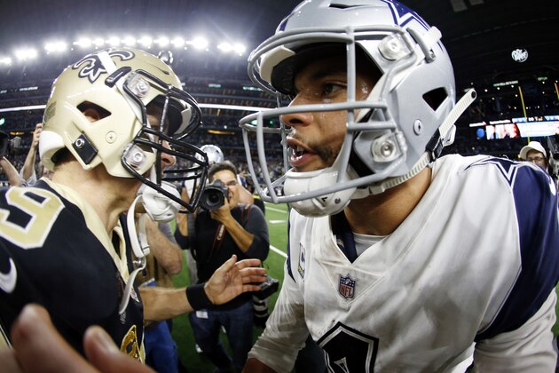 New Orleans Saints quarterback Drew Brees (9) and Dallas Cowboys quarterback Dak Prescott (4) meet on the field following an NFL football game, in Arlington, Texas, Thursday, Nov. 29, 2018. (AP Photo/Ron Jenkins)