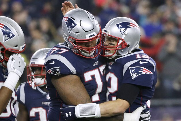 New England Patriots quarterback Tom Brady, right, celebrates a touchdown run by James Develin with tackle Trent Brown, left, during the second half of an NFL football game against the Minnesota Vikings, Sunday, Dec. 2, 2018, in Foxborough, Mass. (AP Photo/Elise Amendola)