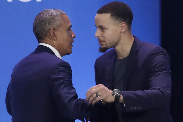 Former President Barack Obama, left, hugs Golden State Warriors basketball player Stephen Curry after speaking at the My Brother's Keeper Alliance Summit in Oakland, Calif., Tuesday, Feb. 19, 2019. (AP Photo/Jeff Chiu)