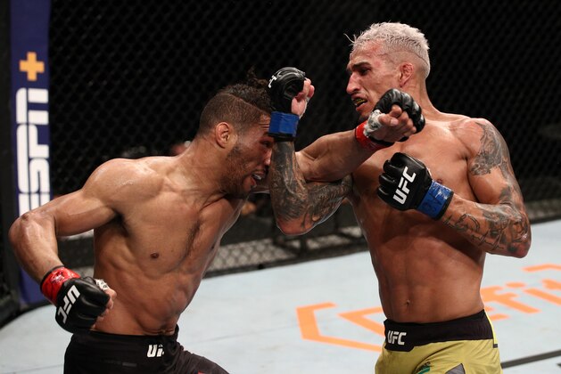 BRASILIA, BRAZIL - MARCH 14: (R-L) Charles Oliveira of Brazil and Kevin Lee trade punches in their lightweight fight during the UFC Fight Night event on March 14, 2020 in Brasilia, Brazil. (Photo by Buda Mendes/Zuffa LLC)