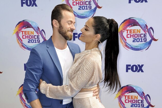 Artem Chigvintsev, left, and Nikki Bella arrive at the Teen Choice Awards on Sunday, Aug. 11, 2019, in Hermosa Beach, Calif. (Photo by Richard Shotwell/Invision/AP)