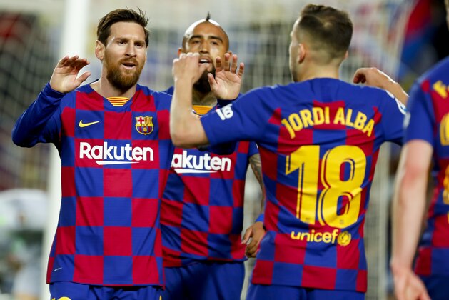 Barcelona's Jordi Alba, right, celebrates with Barcelona's Lionel Messi before the goal he scored was disallowed after a VAR decision during a Spanish La Liga soccer match between Barcelona and Real Sociedad at the Camp Nou stadium in Barcelona, Spain, Saturday, March 7, 2020. (AP Photo/Joan Monfort)