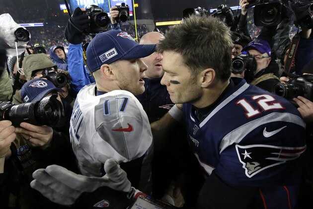 Tennessee Titans quarterback Ryan Tannehill, left, and New England Patriots quarterback Tom Brady speak at midfield after an NFL wild-card playoff football game, Saturday, Jan. 4, 2020, in Foxborough, Mass. (AP Photo/Steven Senne)