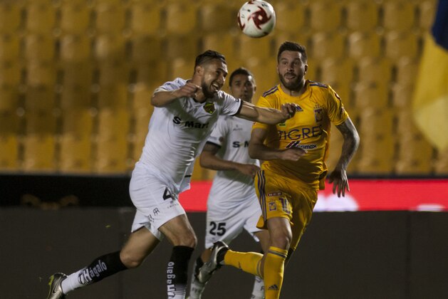 Andre Pierre Gignac (R) of Tigres vies for the ball with Elio Castro (L) of Bravos de Juarez during the Mexican Clausura 2020 tournament football match at Universitario stadium, in Monterrey, Mexico, on March 14, 2020. - The match is played without public as a preventive measure in the face of the global COVID-19 coronavirus pandemic. (Photo by Julio Cesar AGUILAR / AFP) (Photo by JULIO CESAR AGUILAR/AFP via Getty Images)