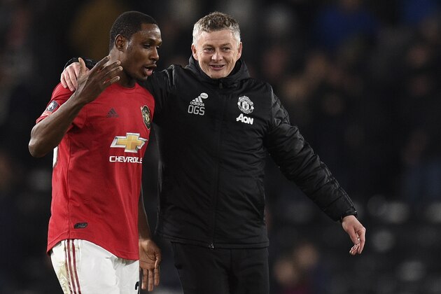 Manchester United's Norwegian manager Ole Gunnar Solskjaer (R) talks to Manchester United's Nigerian striker Odion Ighalo after winning the English FA Cup fifth round football match between Derby County and Manchester United at Pride Park Stadium in Derby, central England on March 5, 2020. (Photo by Oli SCARFF / AFP) / RESTRICTED TO EDITORIAL USE. No use with unauthorized audio, video, data, fixture lists, club/league logos or 'live' services. Online in-match use limited to 120 images. An additional 40 images may be used in extra time. No video emulation. Social media in-match use limited to 120 images. An additional 40 images may be used in extra time. No use in betting publications, games or single club/league/player publications. /  (Photo by OLI SCARFF/AFP via Getty Images)