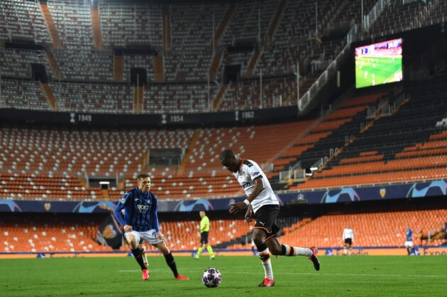 VALENCIA, SPAIN - MARCH 10: (FREE FOR EDITORIAL USE)  In this handout image provided by UEFA, A general view as Josip Ilicic of Atalanta closes down Geoffrey Kondogbia of Valencia during the UEFA Champions League round of 16 second leg match between Valencia CF and Atalanta at Estadio Mestalla on March 10, 2020 in Valencia, Spain. (Photo by UEFA - Handout via Getty Images)