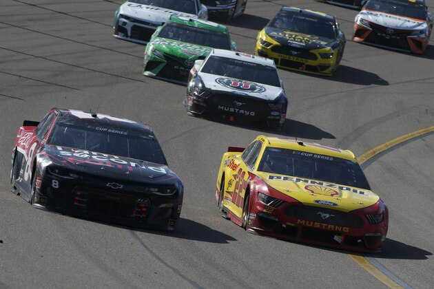 Joey Logano (22) races Tyler Reddick (8) out of Turn 4 during a NASCAR Cup Series auto race at Phoenix Raceway, Sunday, March 8, 2020, in Avondale, Ariz. (AP Photo/Ralph Freso)