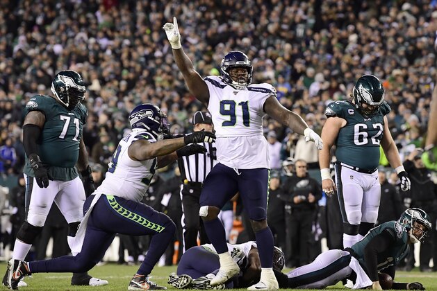 PHILADELPHIA, PENNSYLVANIA - JANUARY 05:  Jarran Reed #91 of the Seattle Seahawks celebrates a defensive stop on quarterback Josh McCown #18 of the Philadelphia Eagles on fourth down in the fourth quarter of the NFC Wild Card Playoff game at Lincoln Financial Field on January 05, 2020 in Philadelphia, Pennsylvania. (Photo by Steven Ryan/Getty Images)