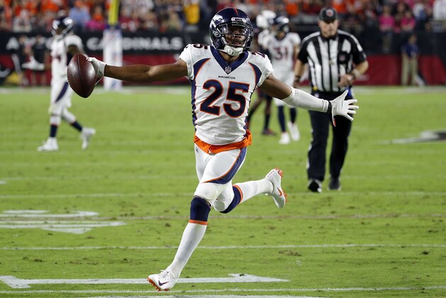 FILE- In this Oct. 18, 2018, file Denver Broncos cornerback Chris Harris Jr. (25) celebrates his interception for a touchdown against the Arizona Cardinals during the first half of an NFL football game in Glendale, Ariz. With Denver out of playoff contention and facing a slew of injuries at the position, the Broncos placed star cornerback Chris Harris Jr. on injured reserve and signed free agent Craig Mager, who was released by the Chargers earlier this season. Harris sustained a chip fracture in his lower right leg two weeks ago.  (AP Photo/Rick Scuteri, File)