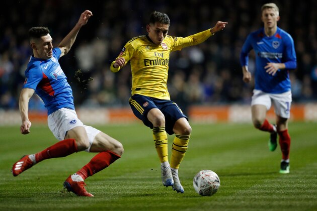 Portsmouth's English defender James Bolton (L) challenges Arsenal's Uruguayan midfielder Lucas Torreira (C) resulting in an injury for Torreira during the English FA Cup fifth round football match between Portsmouth and Arsenal at Fratton Park stadium in Portsmouth, southern England, on March 2, 2020. (Photo by Adrian DENNIS / AFP) / RESTRICTED TO EDITORIAL USE. No use with unauthorized audio, video, data, fixture lists, club/league logos or 'live' services. Online in-match use limited to 120 images. An additional 40 images may be used in extra time. No video emulation. Social media in-match use limited to 120 images. An additional 40 images may be used in extra time. No use in betting publications, games or single club/league/player publications. /  (Photo by ADRIAN DENNIS/AFP via Getty Images)